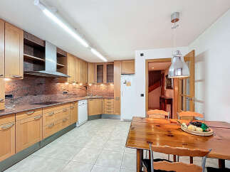 This stunning kitchen boasts beautiful light wood cabinets, granite countertops, and modern appliances.