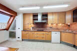 This stunning kitchen boasts a modern design with light wood cabinets and granite countertops.
