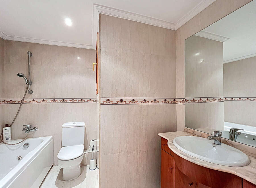 This stunning bathroom boasts a modern design with elegant beige tiles and decorative trim.