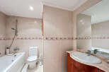 This stunning bathroom boasts a modern design with elegant beige tiles and decorative trim.