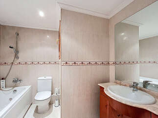 This stunning bathroom boasts a modern design with elegant beige tiles and decorative trim.