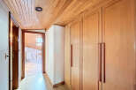 This stunning property boasts a hallway with built-in wooden wardrobes, offering ample storage space.