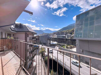 Enjoy breathtaking views from this stunning property! This modern residence features a spacious balcony overlooking a picturesque cityscape and mountains.