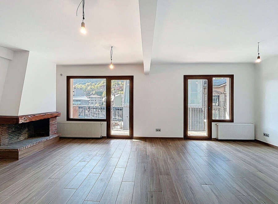 Discover the charm of this stunning property, featuring a spacious living area with beautiful wooden floors.