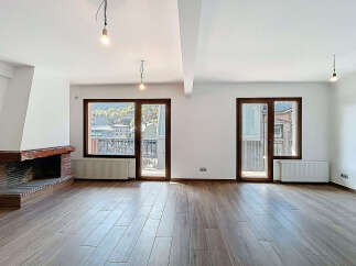 Discover the charm of this stunning property, featuring a spacious living area with beautiful wooden floors.