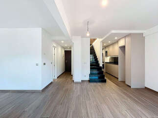 Discover modern living in this stunning property! Featuring a sleek, open-plan design, this home boasts beautiful hardwood floors and a stylish staircase.