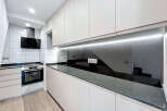 This modern kitchen features sleek, minimalist design with ample storage and counter space.