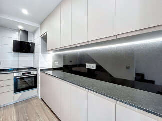 This modern kitchen features sleek, minimalist design with ample storage and counter space.