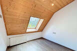 Discover the charm of this unique attic space, featuring a stunning wooden ceiling and a skylight that floods the room with natural light.