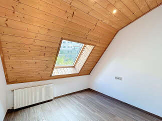 Discover the charm of this unique attic space, featuring a stunning wooden ceiling and a skylight that floods the room with natural light.