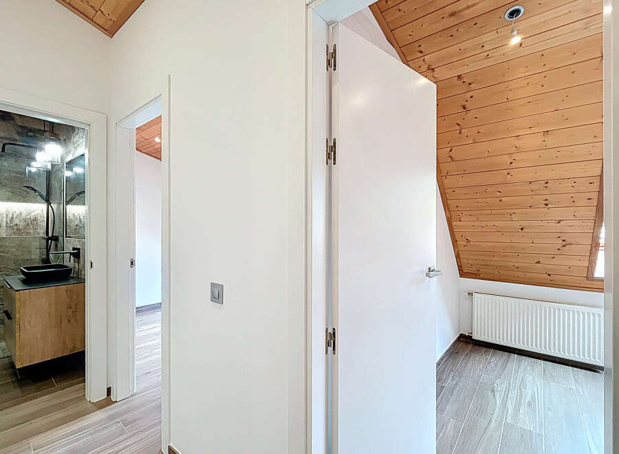 Step into this beautifully designed home featuring a modern bathroom with a sleek black sink and a stylish shower.