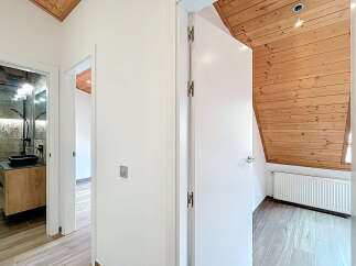 Step into this beautifully designed home featuring a modern bathroom with a sleek black sink and a stylish shower.