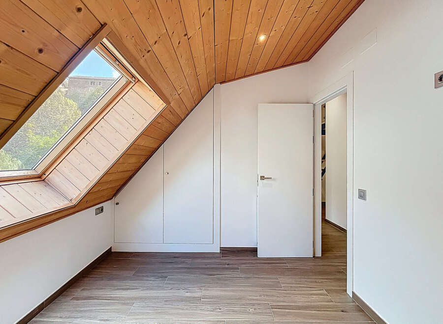 Discover the charm of this unique attic space, featuring a stunning wooden ceiling and a large skylight that floods the room with natural light.