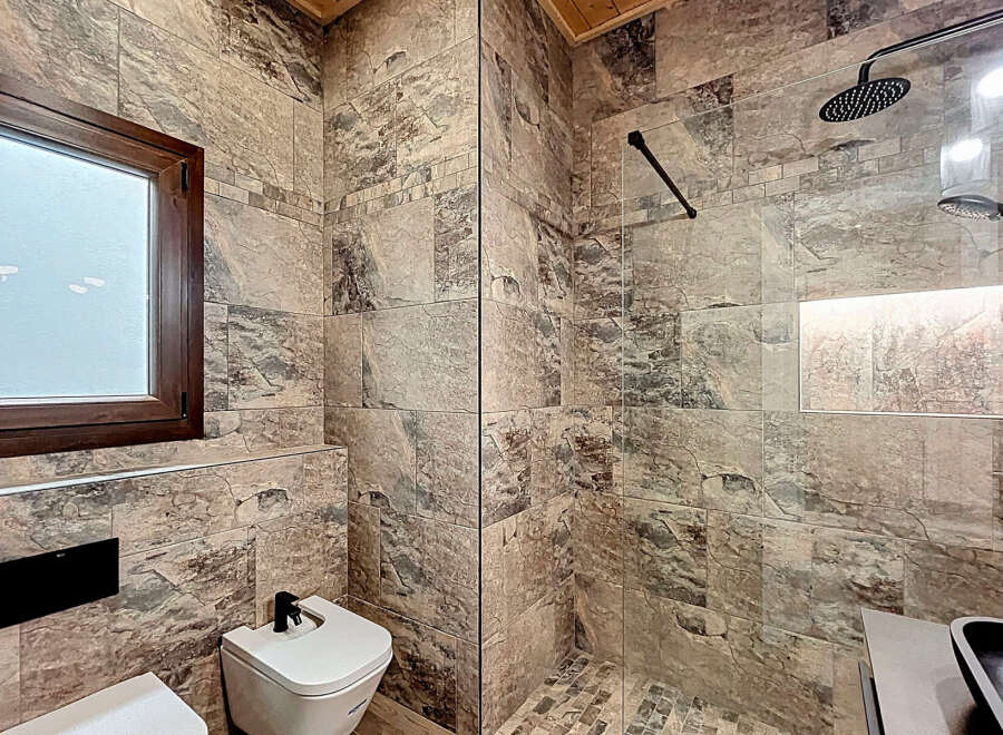 Step into luxury with this stunning bathroom featuring exquisite stone tile work.