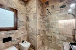 Step into luxury with this stunning bathroom featuring exquisite stone tile work.