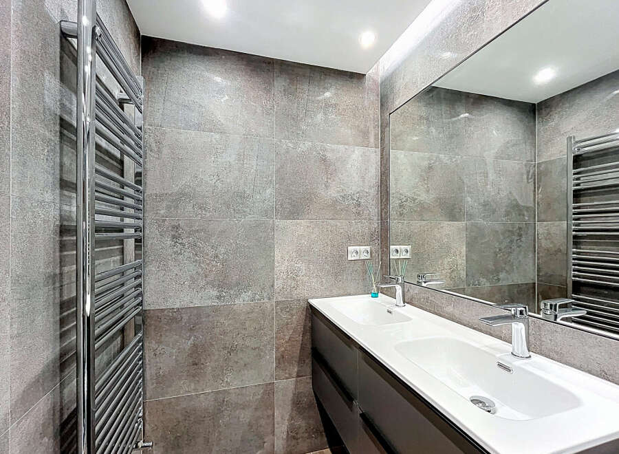 Modern bathroom design featuring a sleek double sink vanity and a large mirror, perfect for a contemporary home.