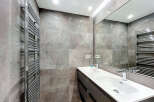 Modern bathroom design featuring a sleek double sink vanity and a large mirror, perfect for a contemporary home.