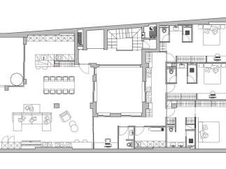This stunning apartment boasts a spacious open-plan living area perfect for entertaining, complete with a large dining table and comfortable lounge furniture.