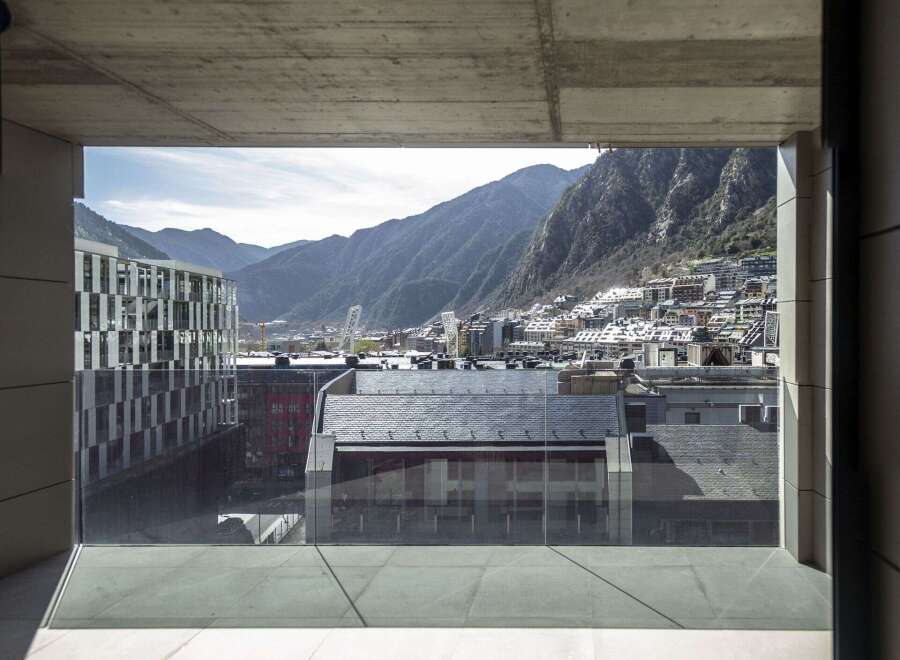 Modern apartment balcony with breathtaking mountain views.