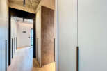 Modern hallway with built-in closets and sleek design.