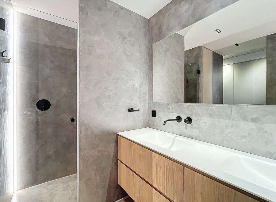 Modern bathroom with double vanity and walk-in shower.