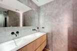 Modern bathroom with double vanity and sleek fixtures.