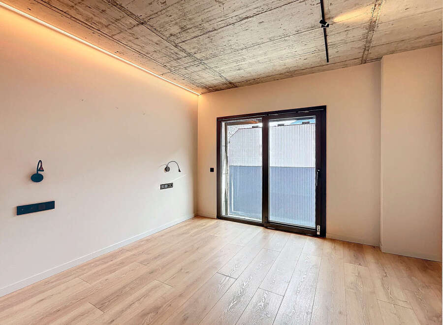Modern apartment featuring sleek design and hardwood floors.