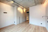 Modern apartment boasts sleek built-in wardrobes and a minimalist design.