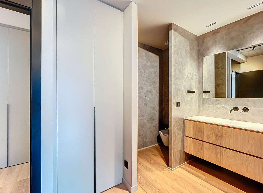 Modern bathroom with built-in cabinets and a sleek, minimalist design.