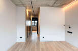 This stunning property boasts a modern, minimalist design with sleek built-in wardrobes and a light oak wood floor.