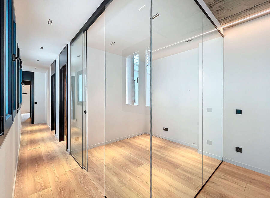 This stunning property boasts a sleek, modern design with glass sliding doors that create a bright and airy atmosphere.
