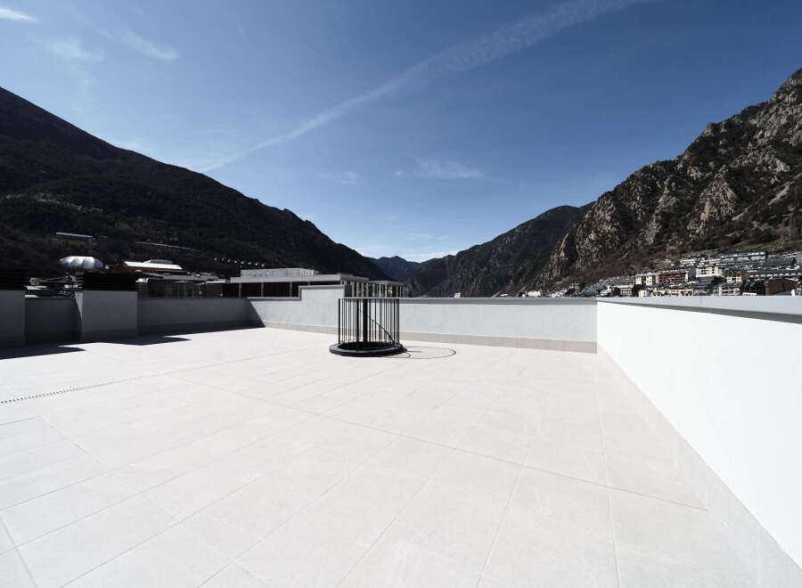 This stunning rooftop terrace offers breathtaking panoramic views of the mountains and city.