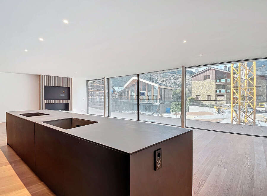 Modern kitchen island with integrated sink and stunning mountain views.