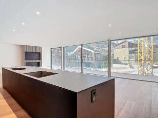 Modern kitchen island with integrated sink and stunning mountain views.