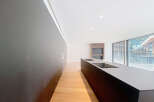 Modern kitchen with sleek dark cabinetry and integrated appliances.