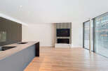 This stunning property boasts an open-plan living area with sleek, modern kitchen and high-end finishes.