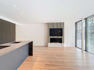 This stunning property boasts an open-plan living area with sleek, modern kitchen and high-end finishes.