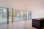 Stunning open-plan living space with floor-to-ceiling windows offering breathtaking mountain views.