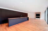 Stunning open-plan living space with sleek, modern kitchen island and hardwood floors.