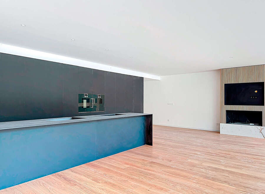 Stunning modern kitchen with sleek dark cabinetry and a built-in island, perfect for entertaining.