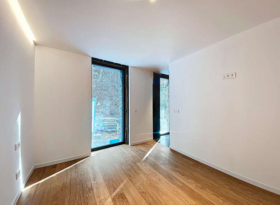 Bright and airy room with large windows offering ample natural light.