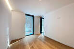 Bright and airy room with large windows offering ample natural light.