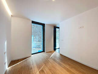 Bright and airy room with large windows offering ample natural light.