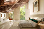 Luxurious bedroom with sloped ceilings and large windows offering abundant natural light and forest views.