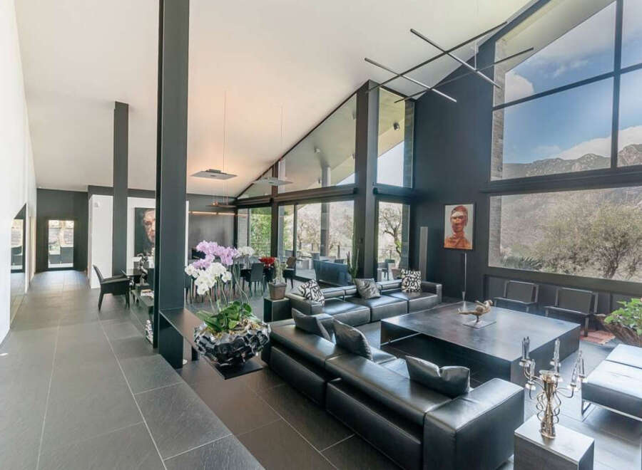 This stunning contemporary home boasts an open floor plan with floor-to-ceiling windows offering breathtaking mountain views.