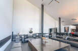 This stunning modern home boasts an open-concept living area with soaring ceilings and sleek, minimalist design.
