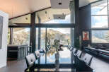 Modern mountain villa with floor-to-ceiling windows offering breathtaking views.