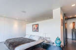 Luxurious modern bedroom with built-in wardrobes and stunning city views.