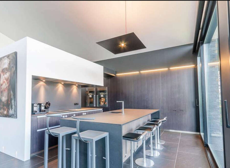 Modern kitchen with sleek countertops and high-end appliances.
