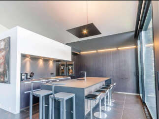 Modern kitchen with sleek countertops and high-end appliances.